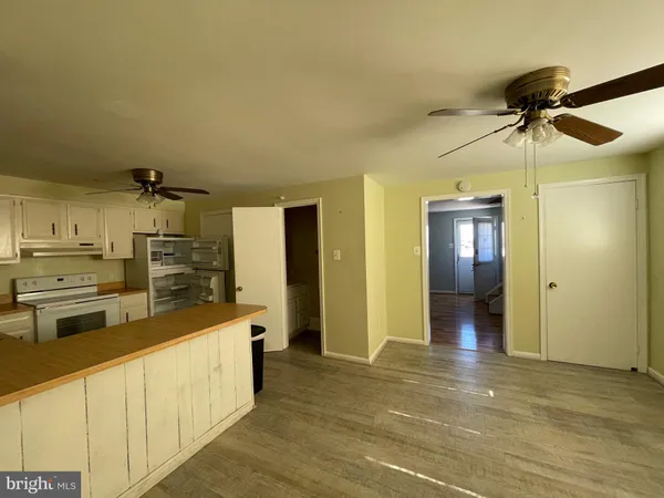 a kitchen with stainless steel appliances a refrigerator and a stove top oven