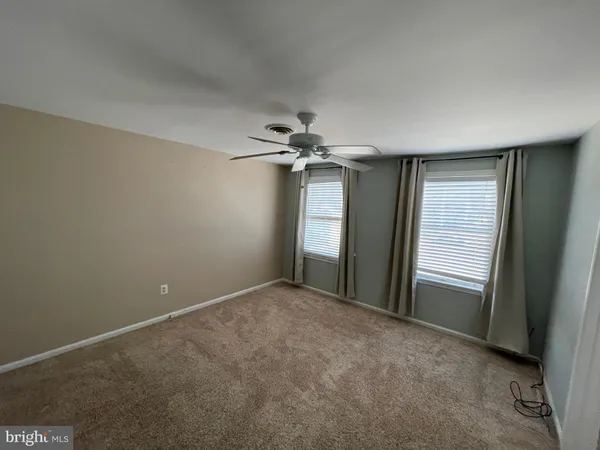 a view of a livingroom with a ceiling fan and window