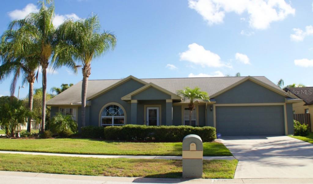 1735 Compton Street Brandon, FL 33511 - Photo 1 of 1 a front view of a house with a garden and yard