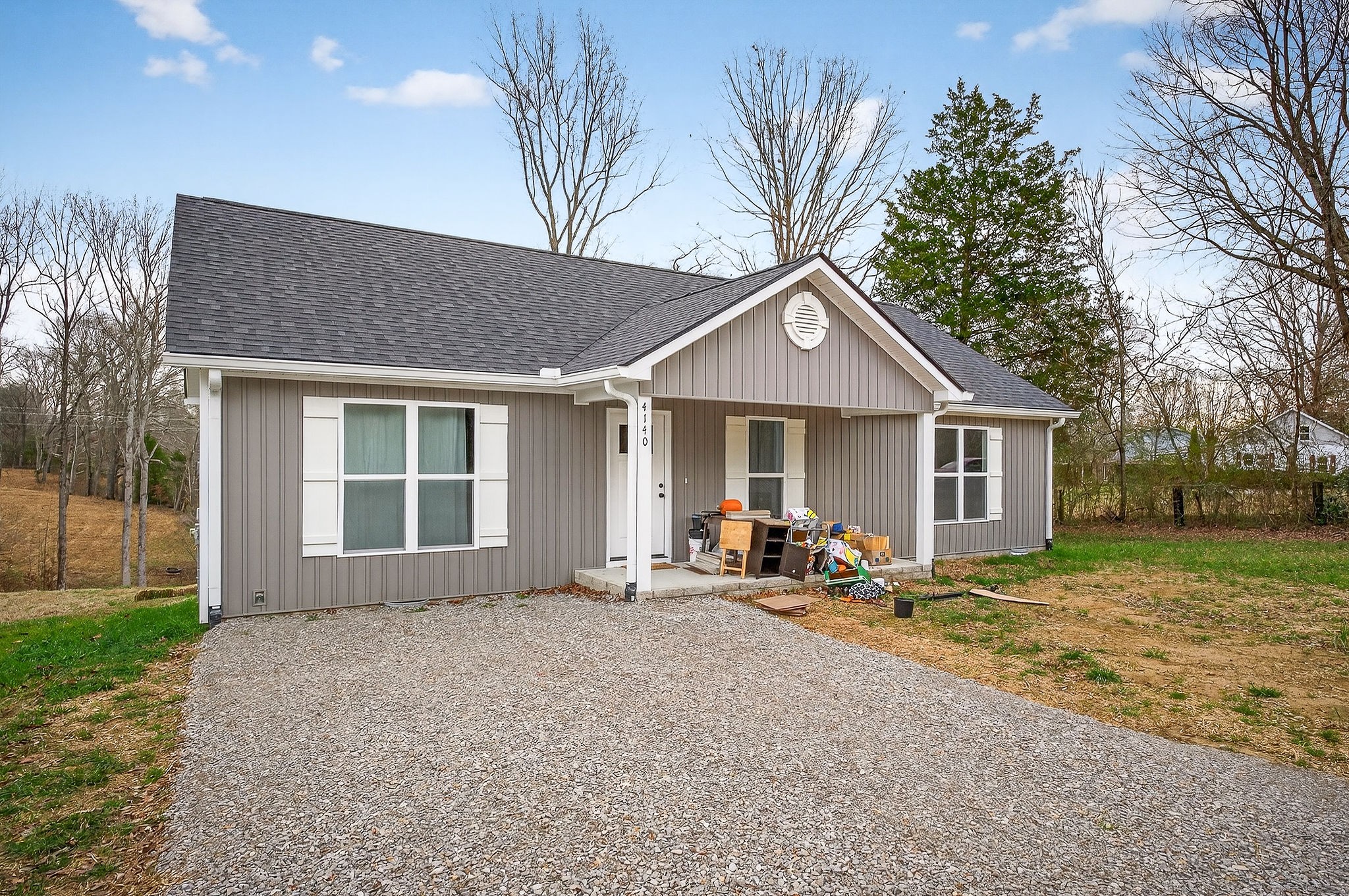 a front view of a house with sitting area and garden