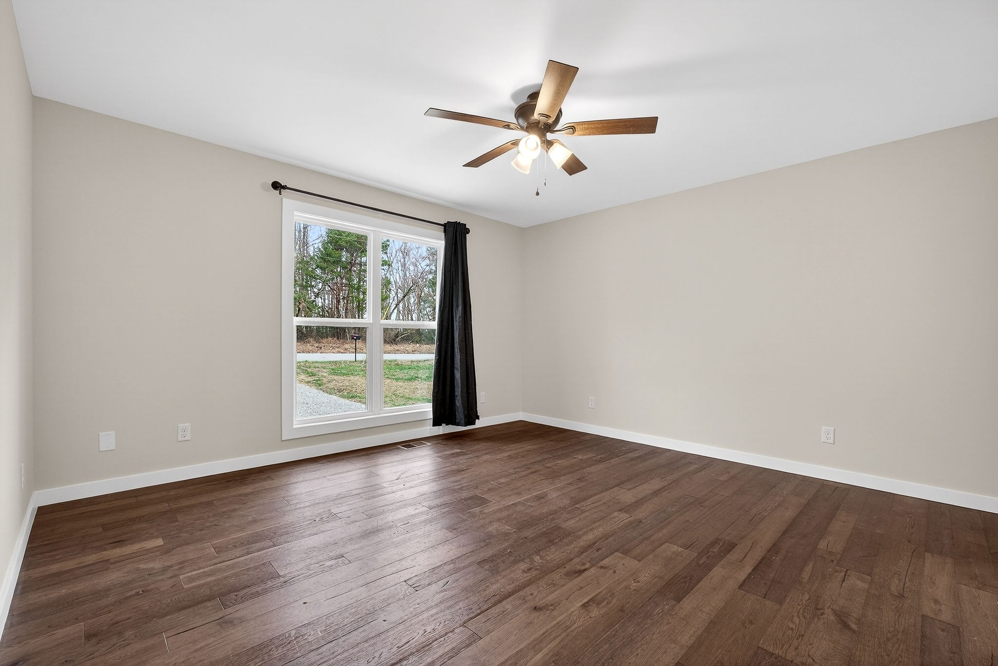 4140 Eller Ridge Road Cookeville, TN 38506 - Photo 11 of 33 an empty room with wooden floor fan and windows