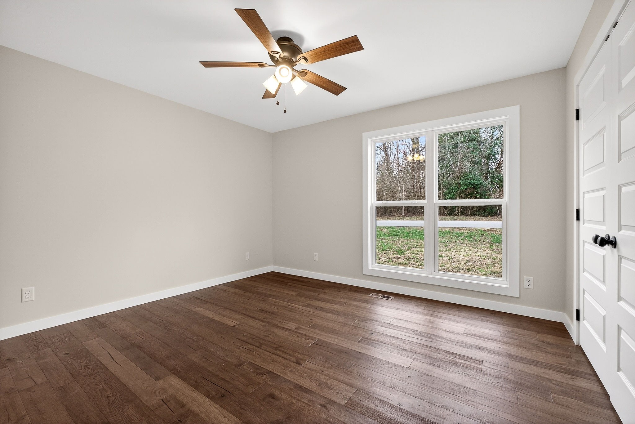 4140 Eller Ridge Road Cookeville, TN 38506 - Photo 28 of 33 an empty room with wooden floor and windows