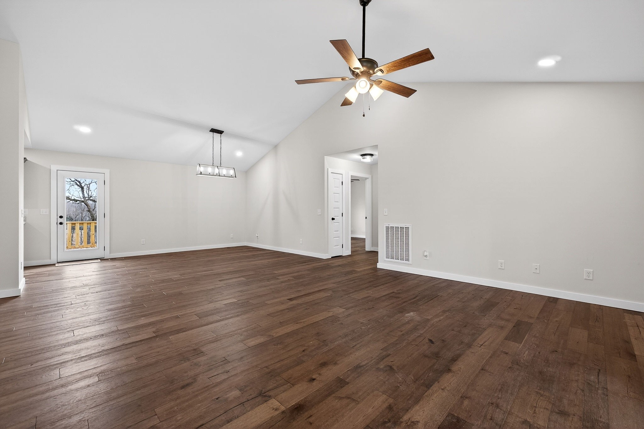 4140 Eller Ridge Road Cookeville, TN 38506 - Photo 29 of 33 an empty room with wooden floor fan and windows