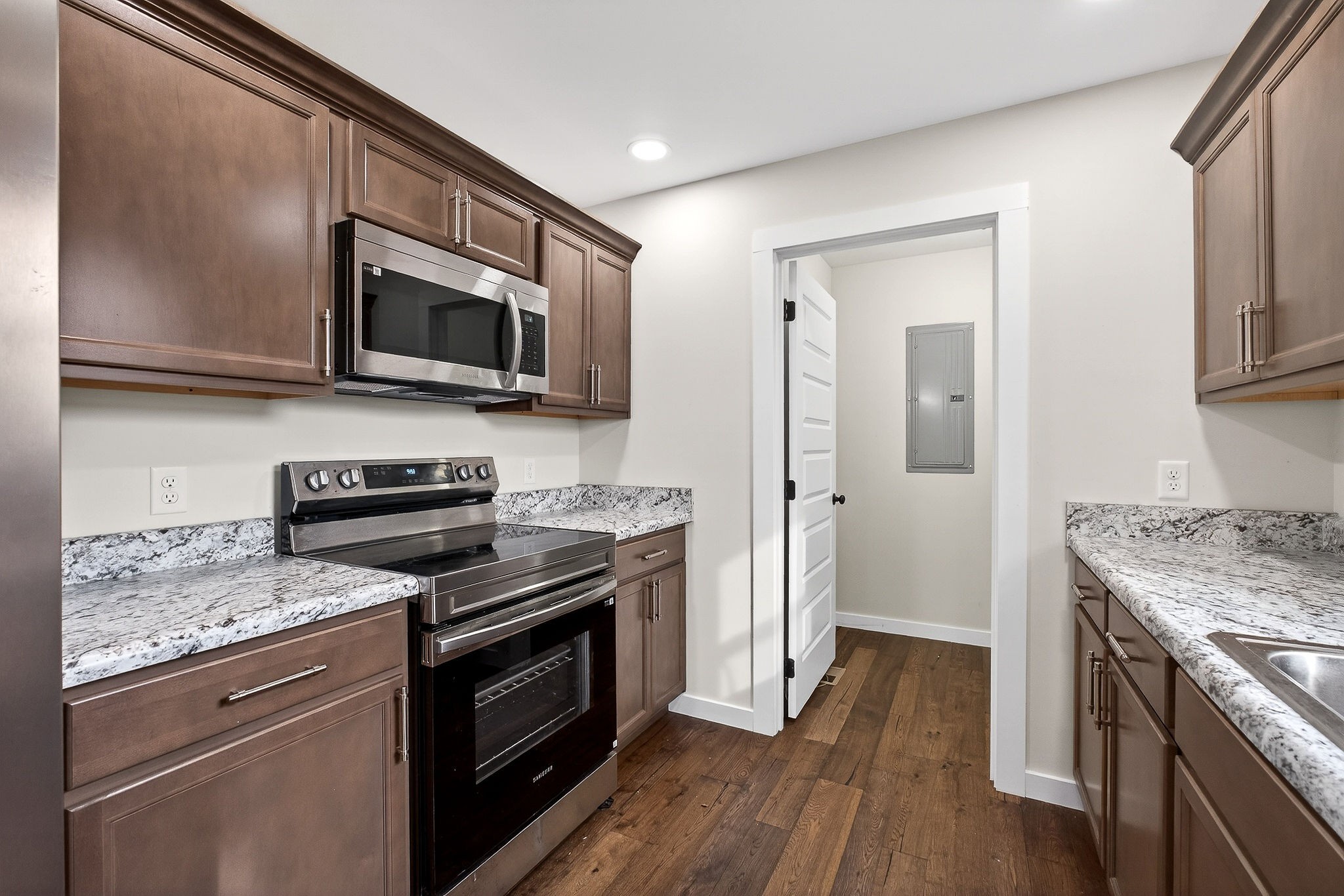 4140 Eller Ridge Road Cookeville, TN 38506 - Photo 5 of 33 a kitchen with stainless steel appliances a stove microwave and sink