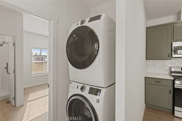 a view of a storage and utility room with washer and dryer