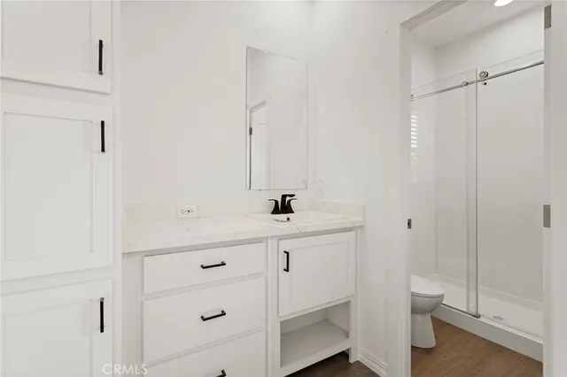 a bathroom with a sink a toilet and a shower