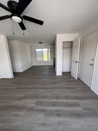 a view of an empty room and wooden floor