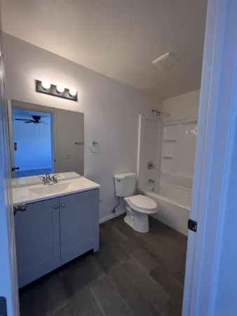 a bathroom with a double vanity sink toilet and shower