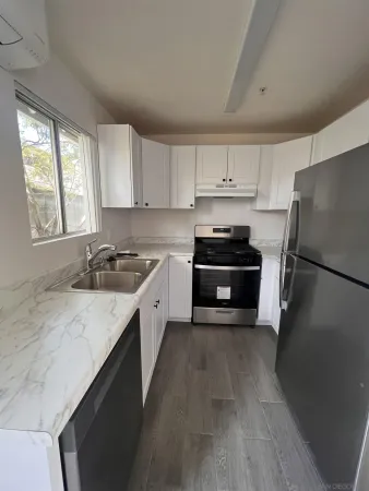 a kitchen with a refrigerator a sink and a stove