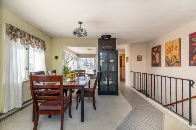 a view of a dining room with furniture and window