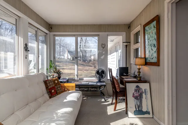 a living room with furniture and large windows