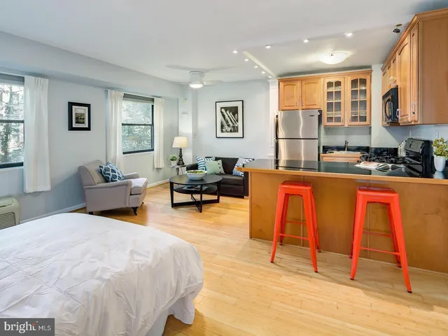 a bedroom with furniture and a wooden floor