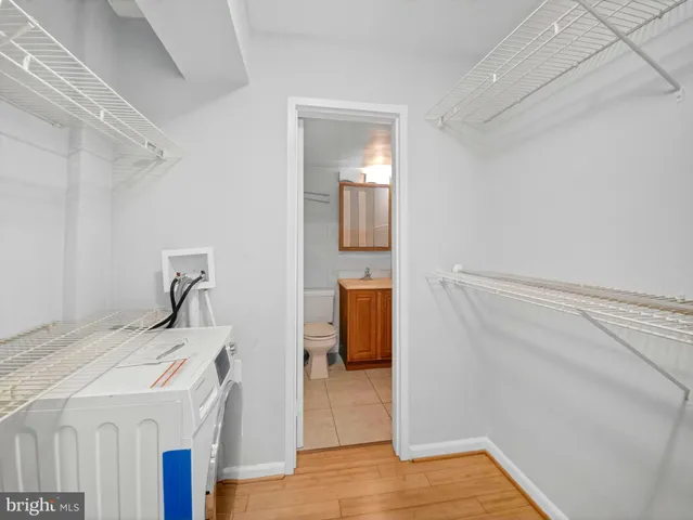 a room that has a bed and dresser in it