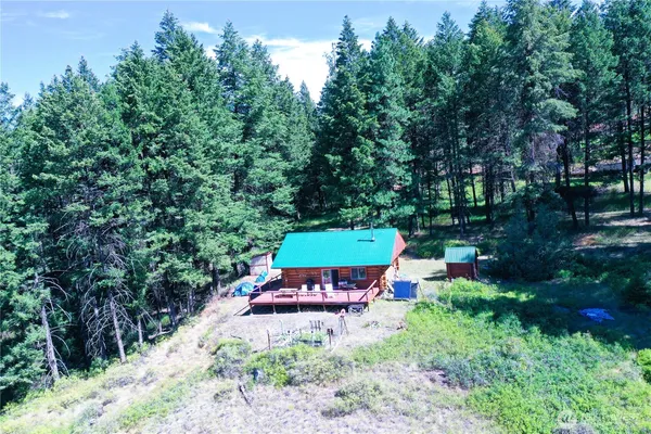 an aerial view of a house with a yard