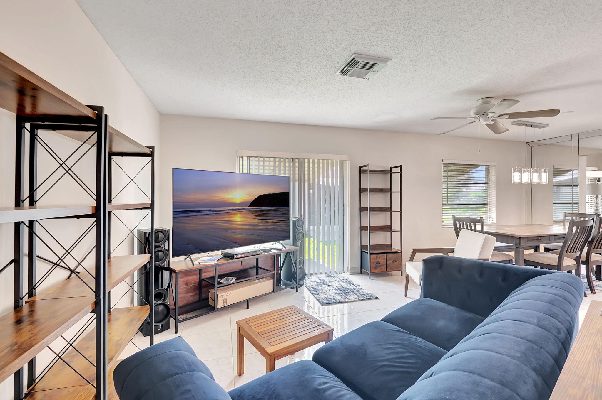 6078 Dusenburg Road Delray Beach, FL 33484 - Photo 12 of 78 a living room with furniture and a flat screen tv