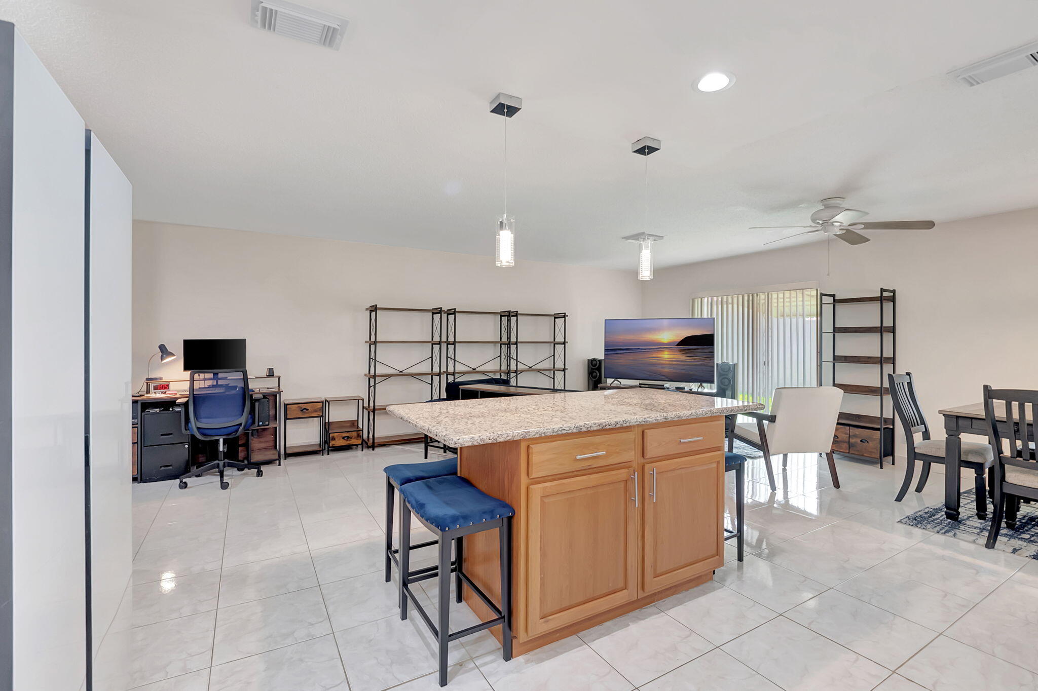 6078 Dusenburg Road Delray Beach, FL 33484 - Photo 18 of 78 a kitchen that has a lot of cabinets in it with a dining table and chairs