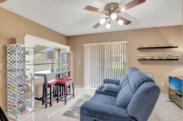 a bathroom with a granite countertop sink a toilet a mirror and shower