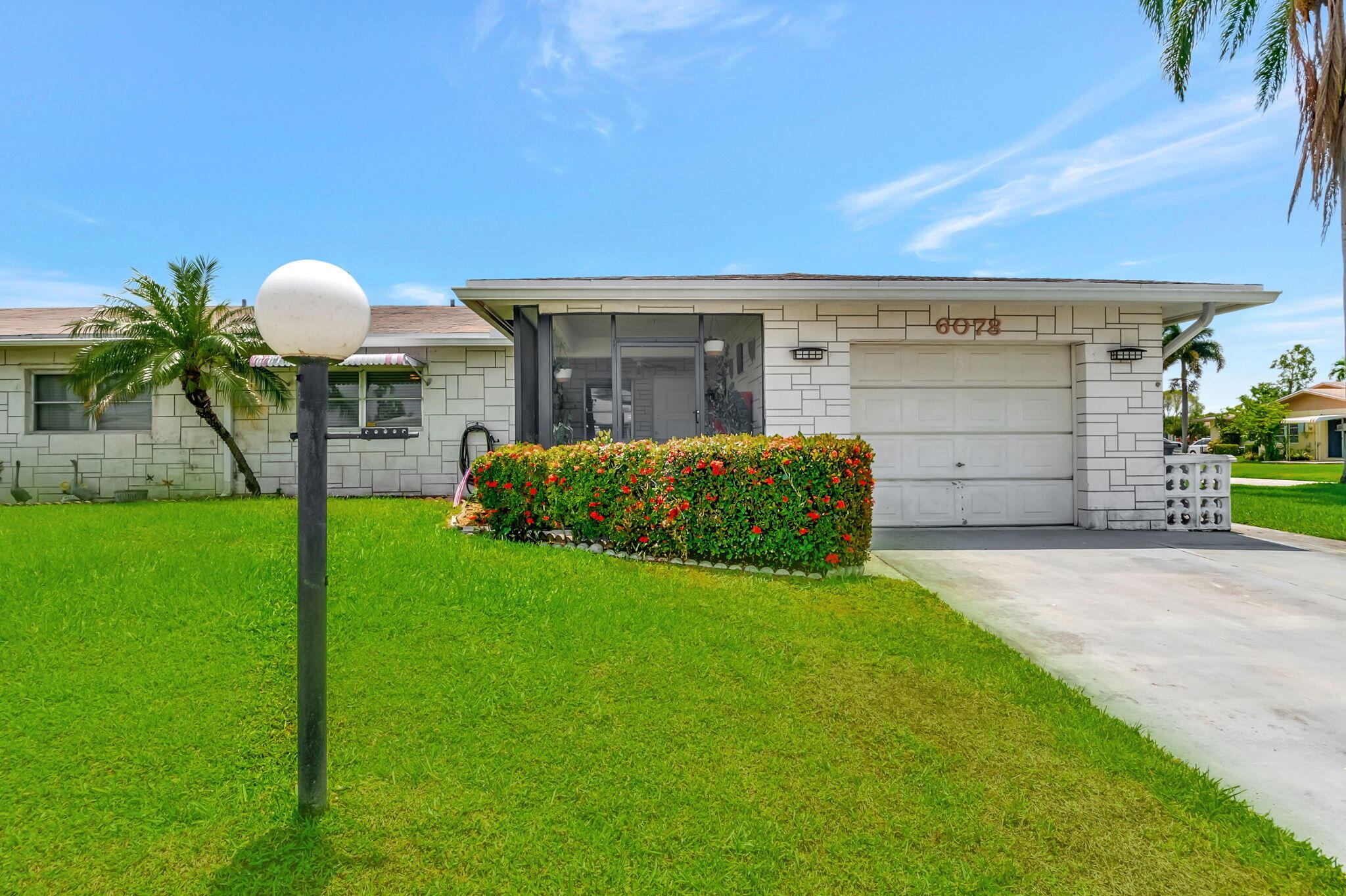 6078 Dusenburg Road Delray Beach, FL 33484 - Photo 2 of 78 a front view of a house with a garden and yard