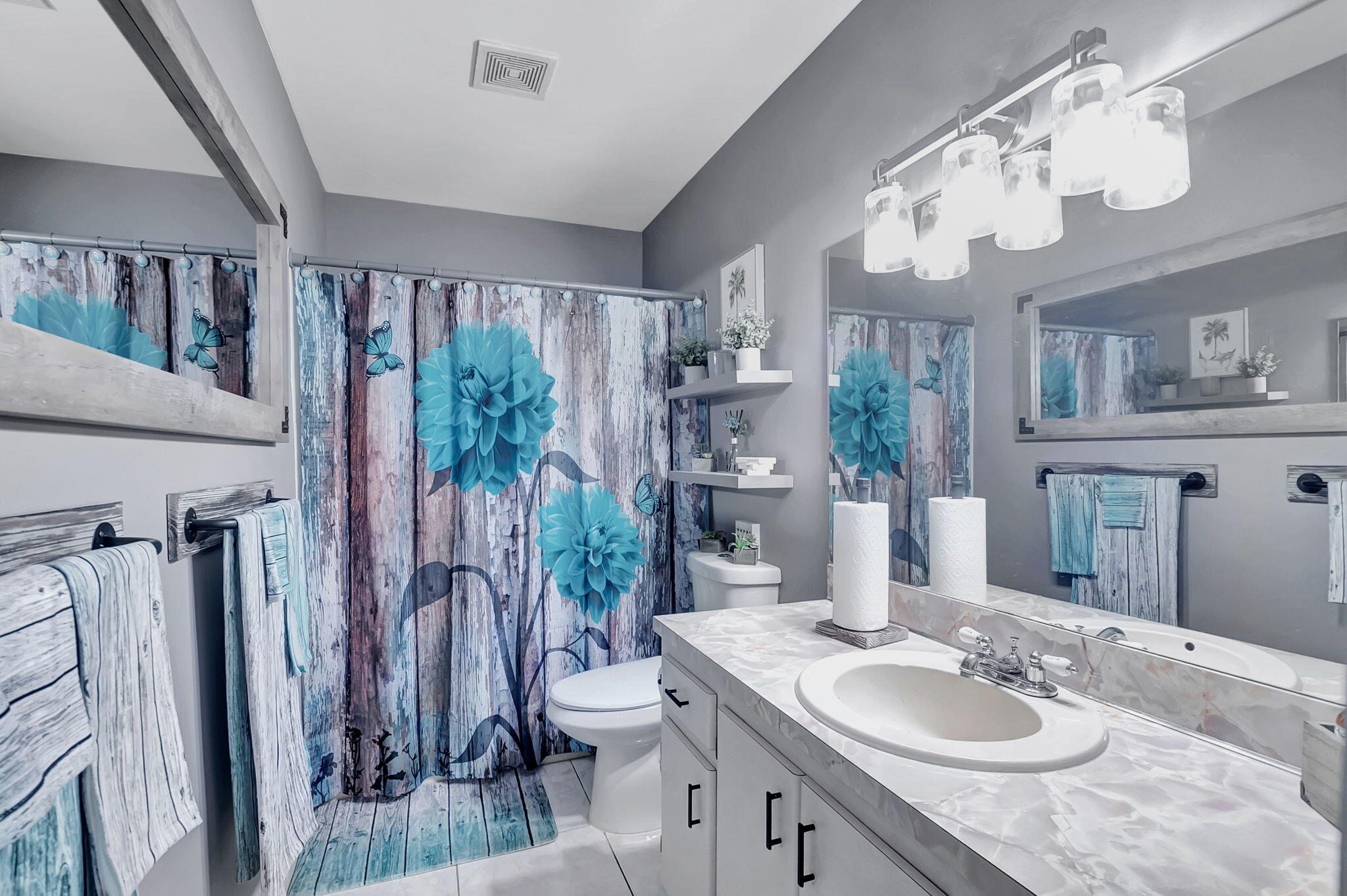 6078 Dusenburg Road Delray Beach, FL 33484 - Photo 22 of 78 a bathroom with a granite countertop sink a toilet and a mirror