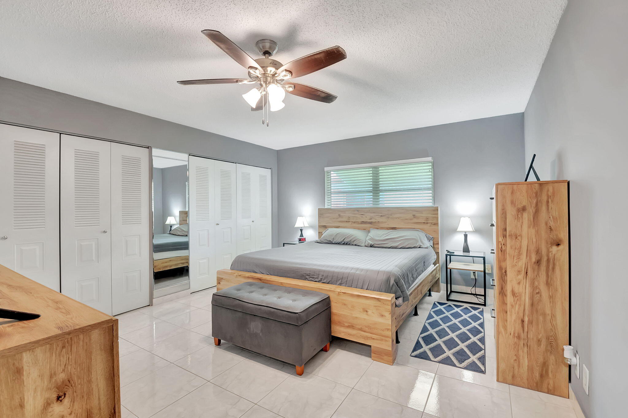 6078 Dusenburg Road Delray Beach, FL 33484 - Photo 23 of 78 a bedroom with a bed and a chandelier