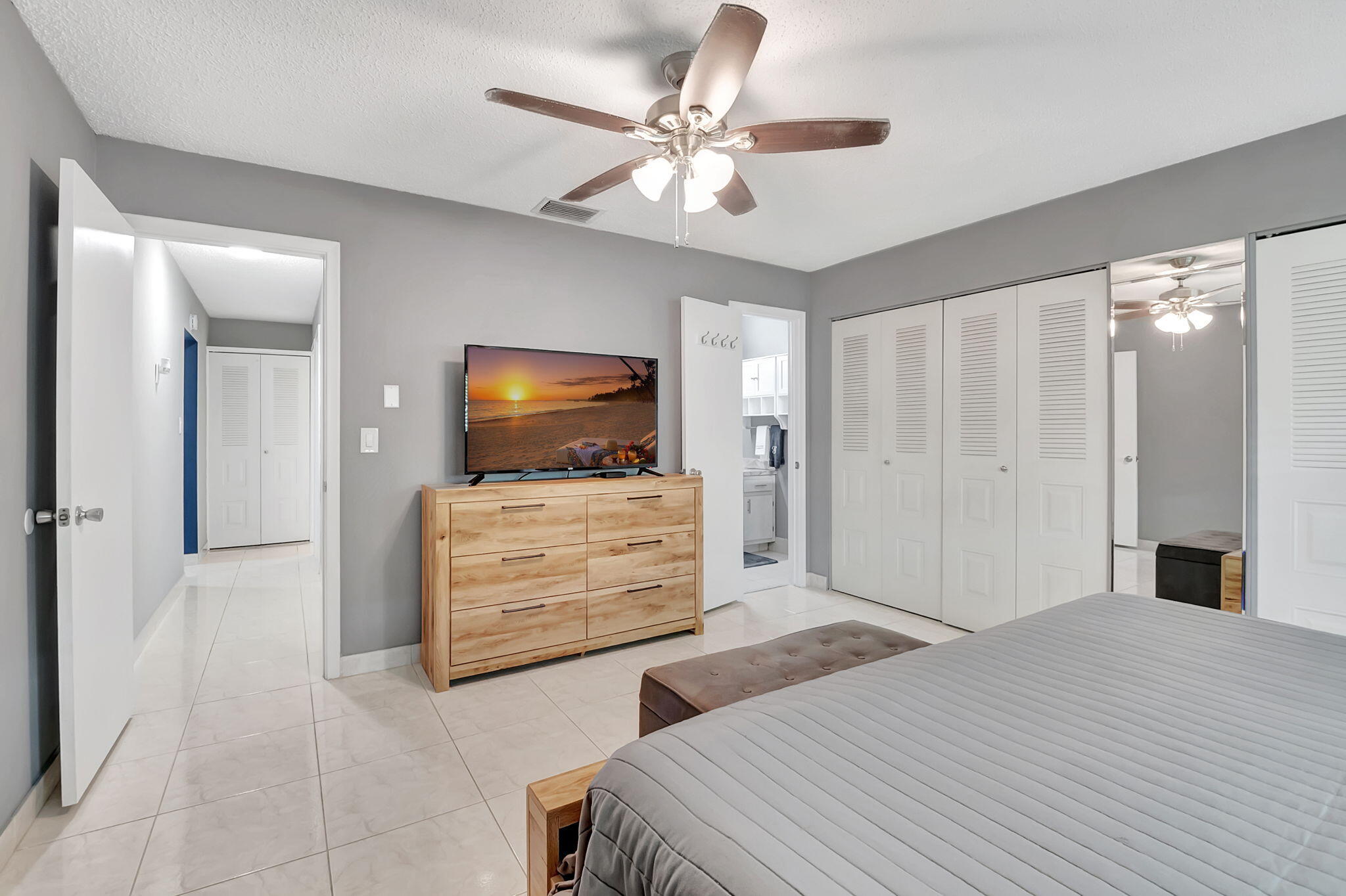 6078 Dusenburg Road Delray Beach, FL 33484 - Photo 24 of 78 a bedroom with a bed and a flat screen tv