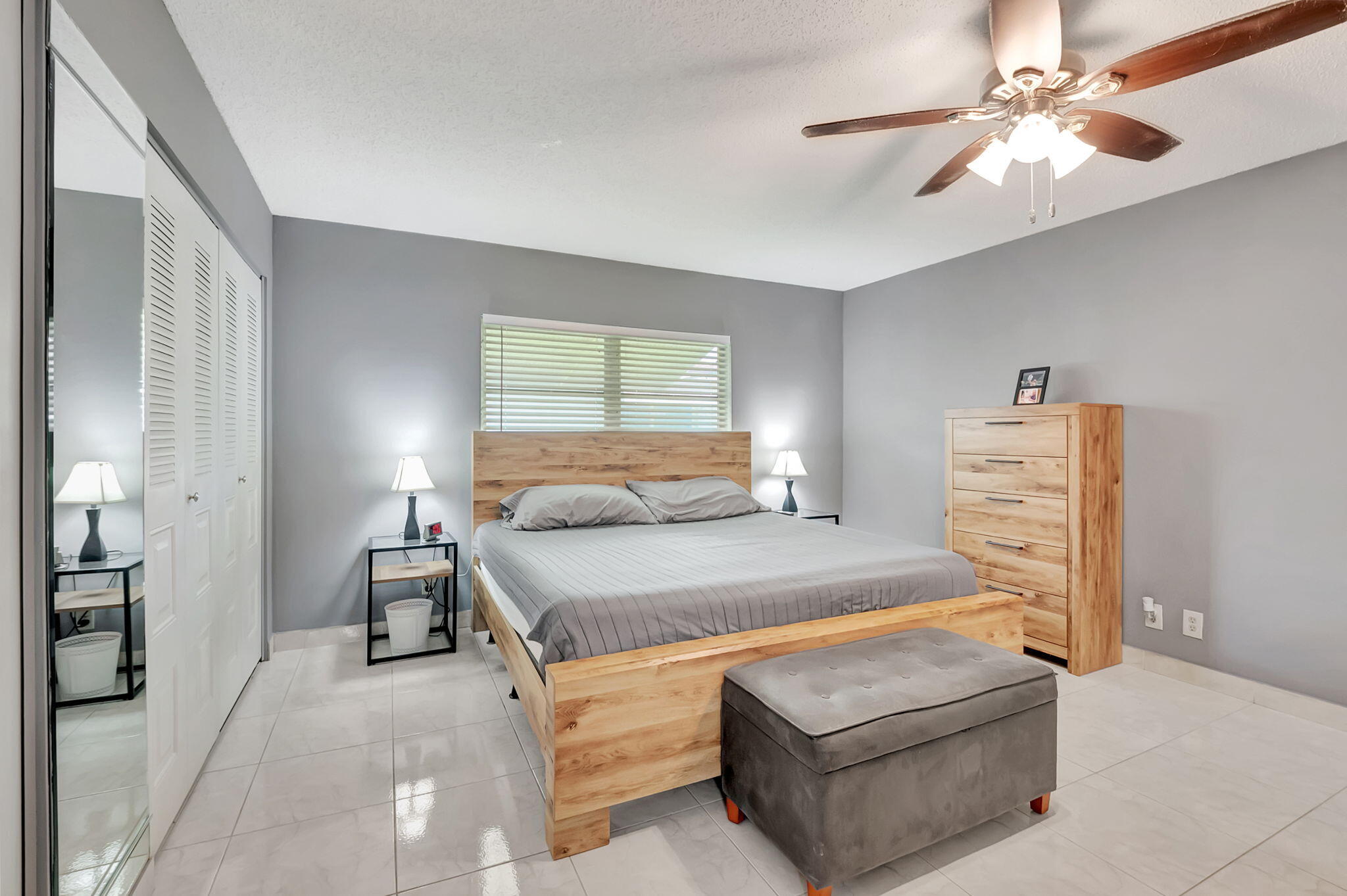 6078 Dusenburg Road Delray Beach, FL 33484 - Photo 25 of 78 a bedroom with a bed couch and a window
