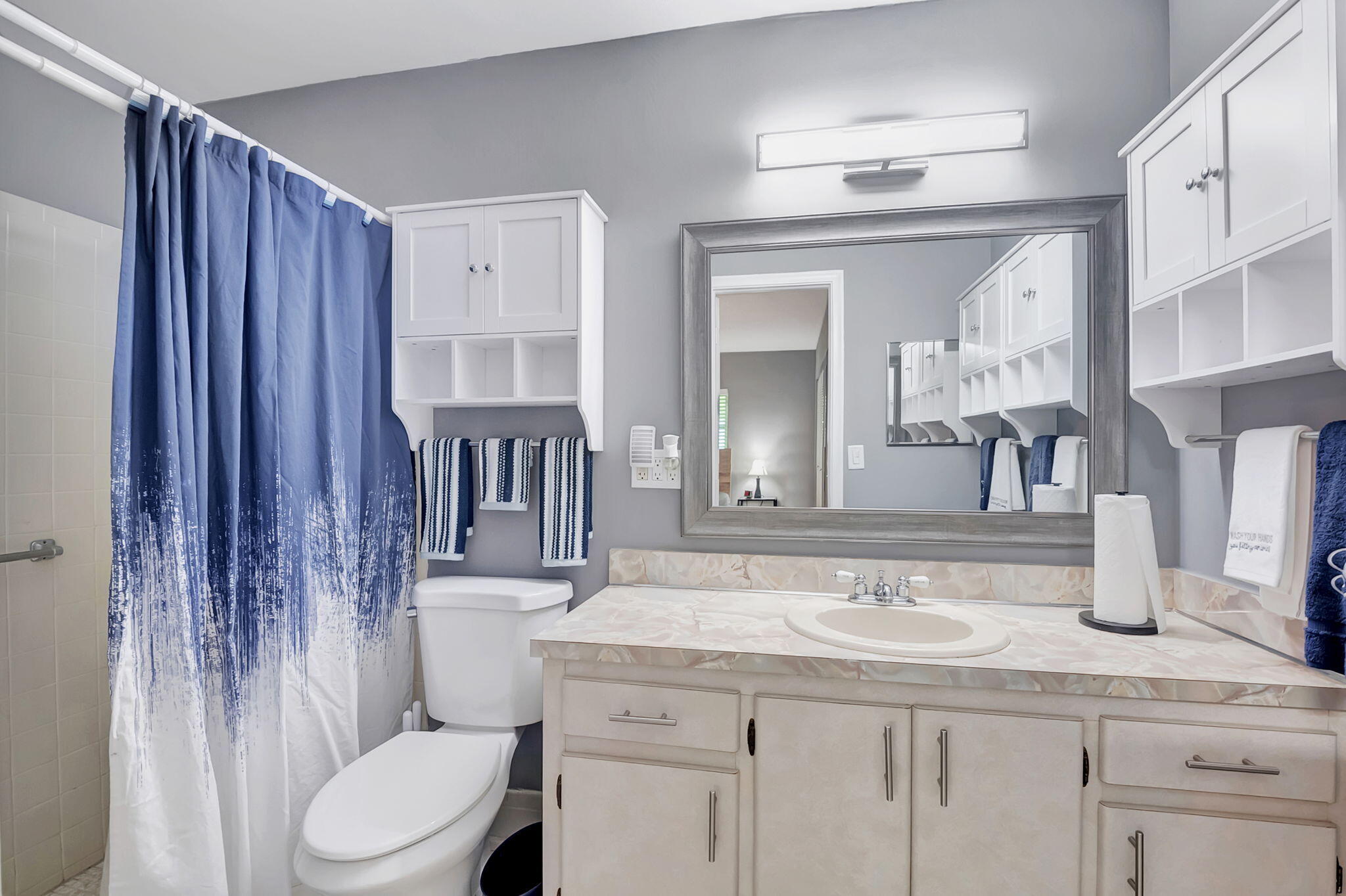 6078 Dusenburg Road Delray Beach, FL 33484 - Photo 26 of 78 a bathroom with a granite countertop sink a toilet a mirror and shower