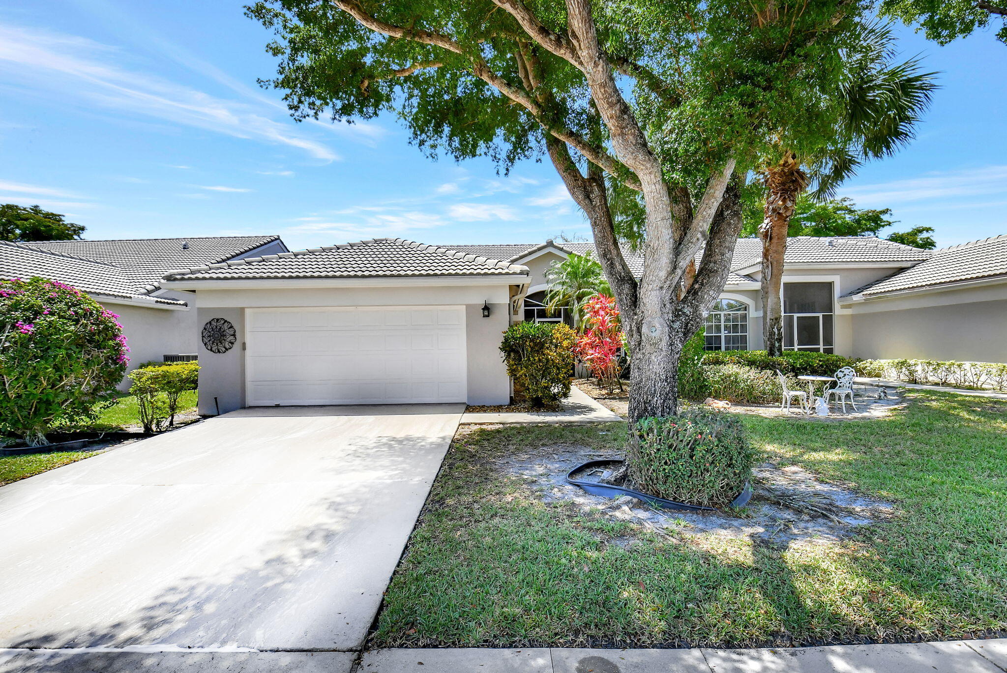 6078 Dusenburg Road Delray Beach, FL 33484 - Photo 28 of 78 a front view of a house with garden