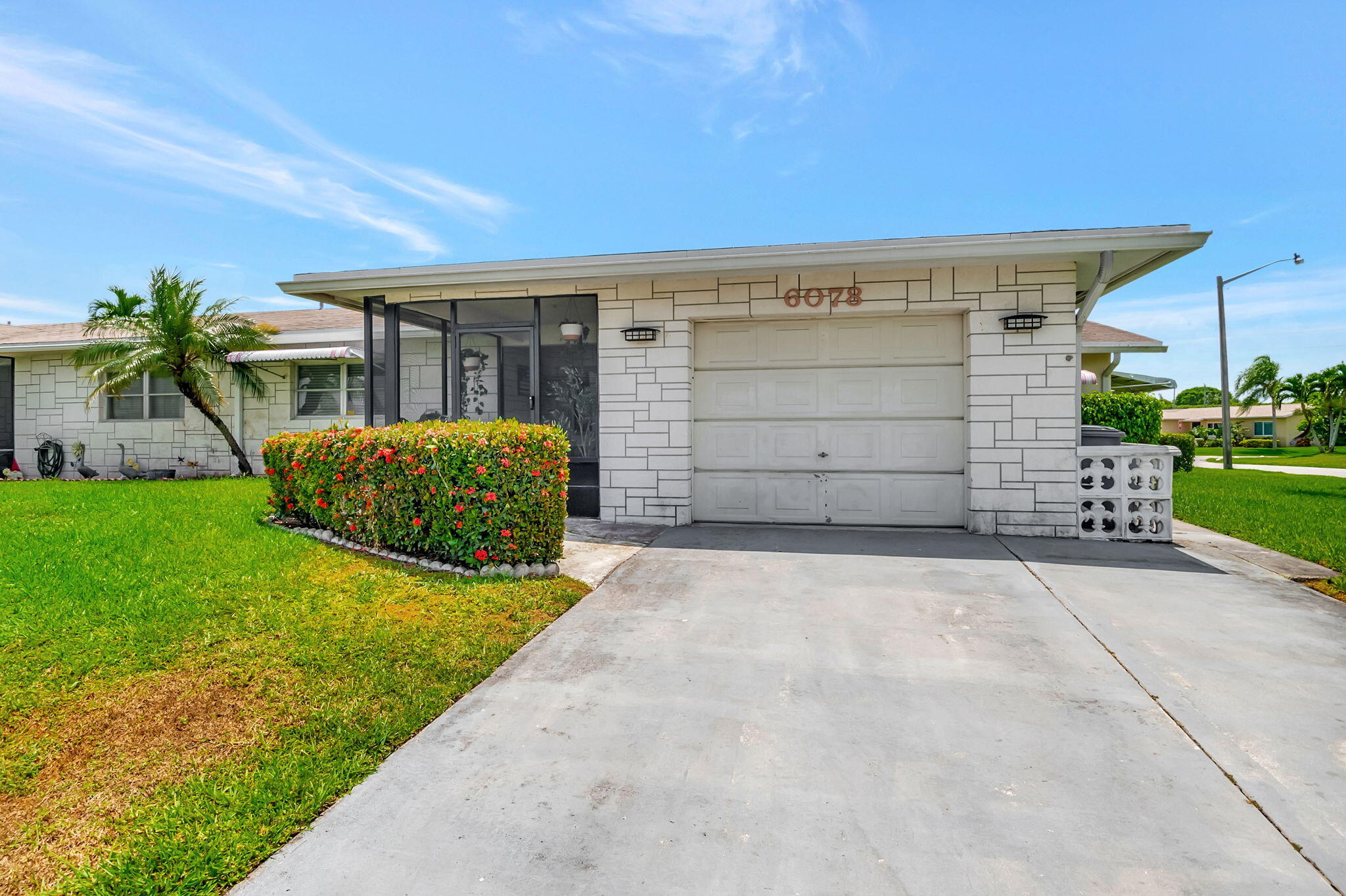 6078 Dusenburg Road Delray Beach, FL 33484 - Photo 4 of 78 a view of a house with a yard and garage