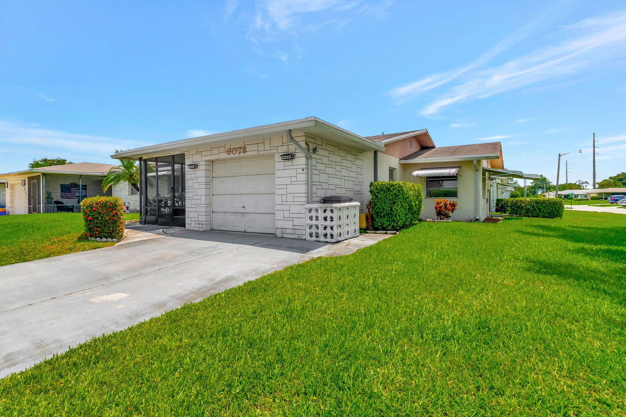 6078 Dusenburg Road Delray Beach, FL 33484 - Photo 5 of 78 a front view of a house with a yard and garage