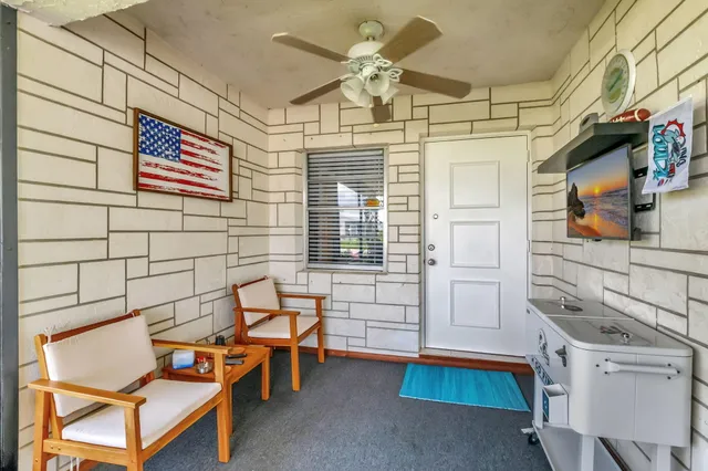 a view of a workspace with furniture and a kitchen