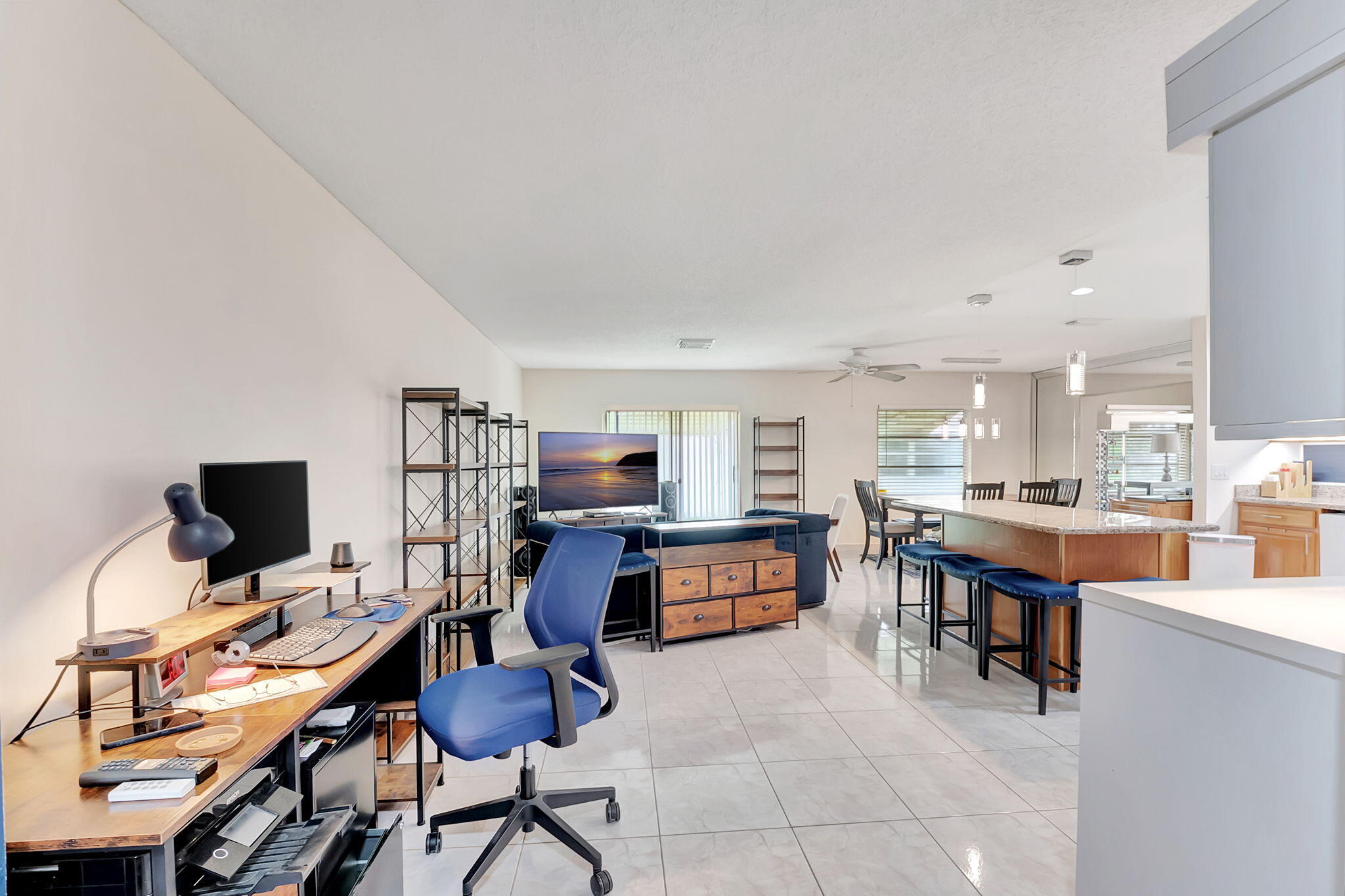 6078 Dusenburg Road Delray Beach, FL 33484 - Photo 10 of 78 a view of a workspace with furniture and a kitchen