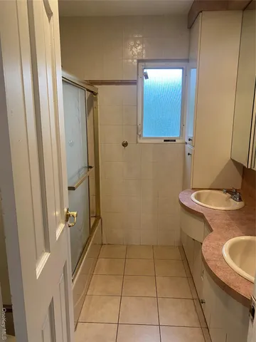 a bathroom with a glass shower door