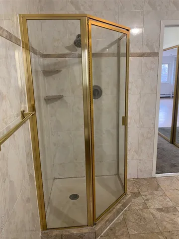 a bathroom with a double vanity sink mirror and shower