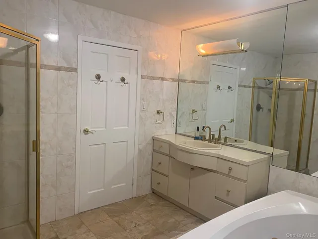 a spacious bathroom with a shower and a sink