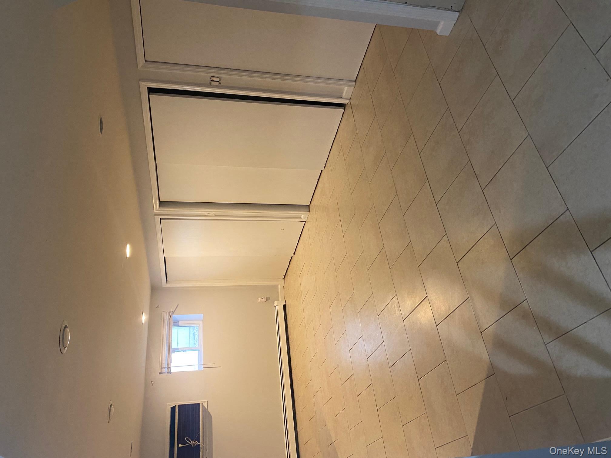 723 Hungry Harbor Road Valley Stream, NY 11581 - Photo 15 of 19 a view of an empty room with a window