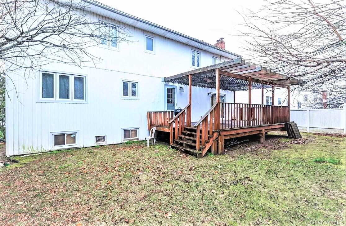 723 Hungry Harbor Road Valley Stream, NY 11581 - Photo 19 of 19 a view of a house with a yard and deck