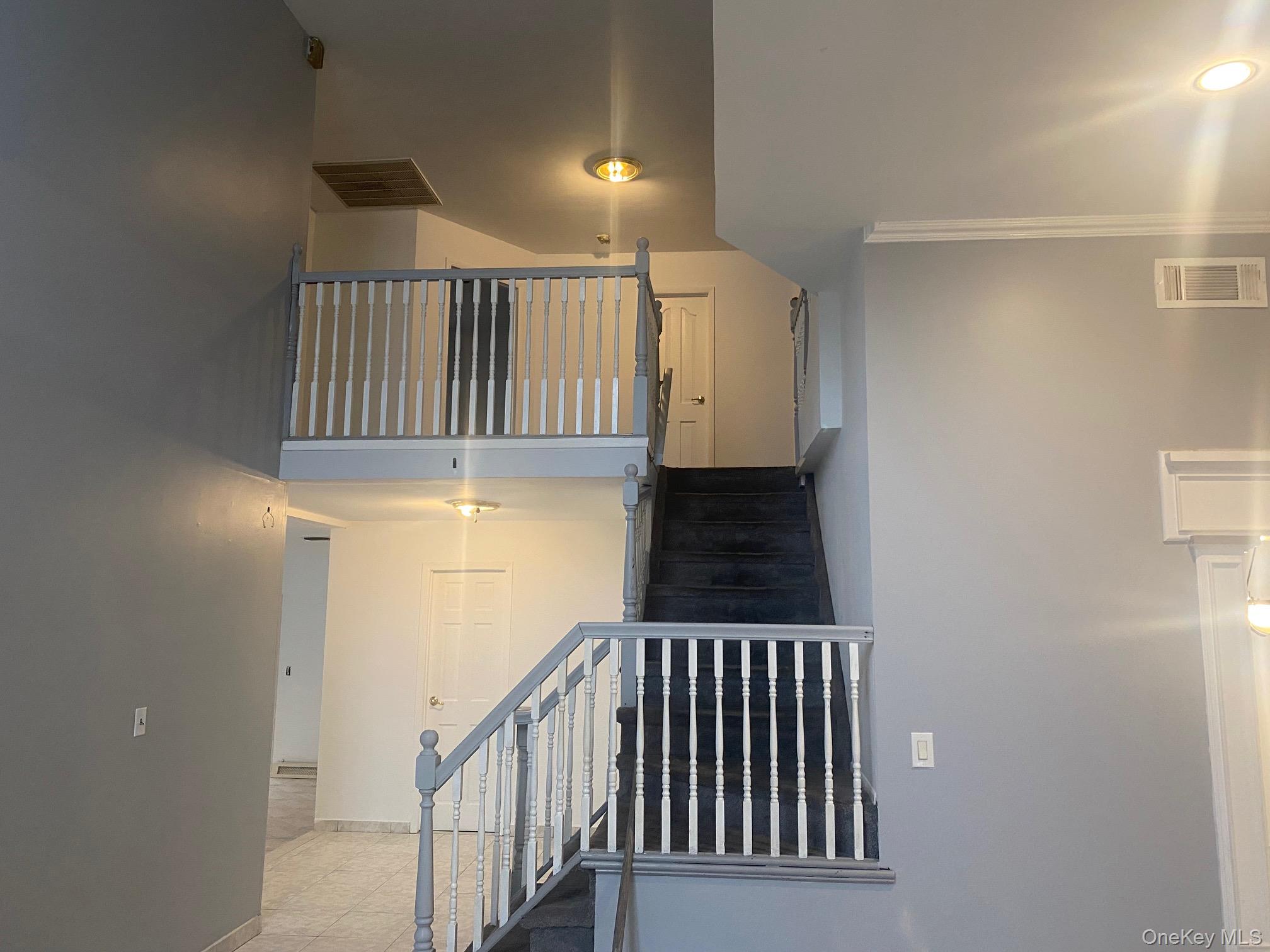 723 Hungry Harbor Road Valley Stream, NY 11581 - Photo 5 of 19 a view of a hallway with wooden floor and staircase