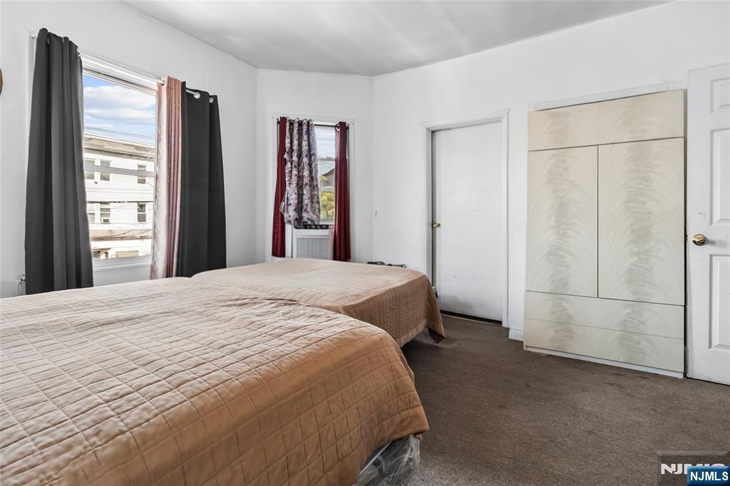 262 Union Avenue Paterson, NJ 07502 - Photo 13 of 17 a spacious bedroom with a bed and a window
