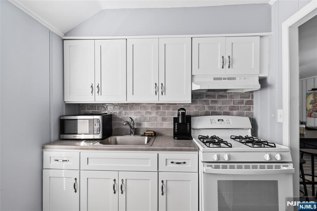 262 Union Avenue Paterson, NJ 07502 - Photo 14 of 17 a kitchen with white cabinets and appliances