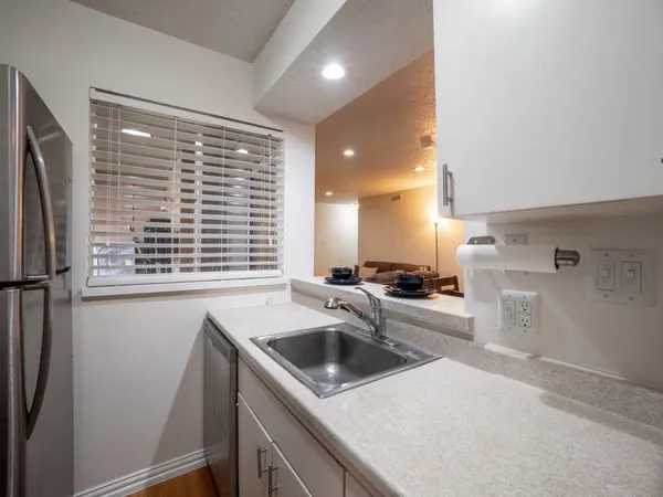 a kitchen with a refrigerator and a stove top oven