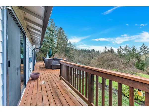 a view of balcony with wooden floor and fence