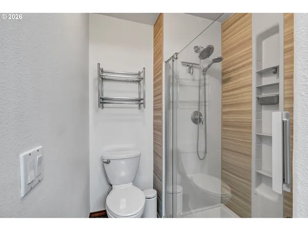 a bathroom with a toilet and a shower