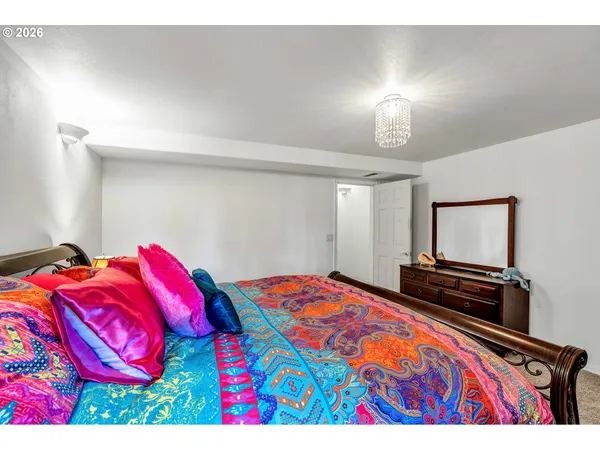 a bedroom with a bed and a television