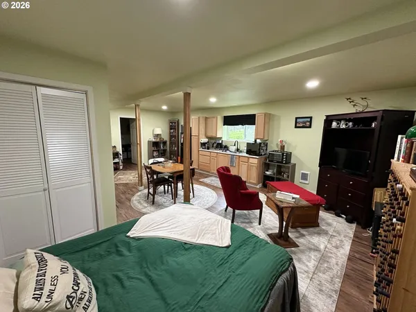 a living room with furniture and a dining table with kitchen view