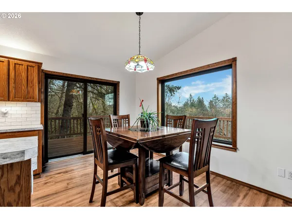 a dining room with furniture a chandelier and wooden floor