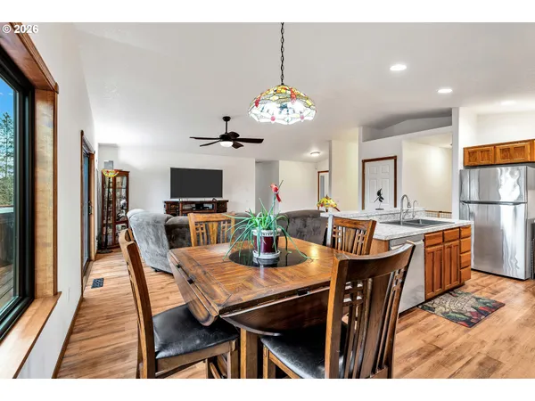 a view of a dining room with furniture a chandelier and wooden floor