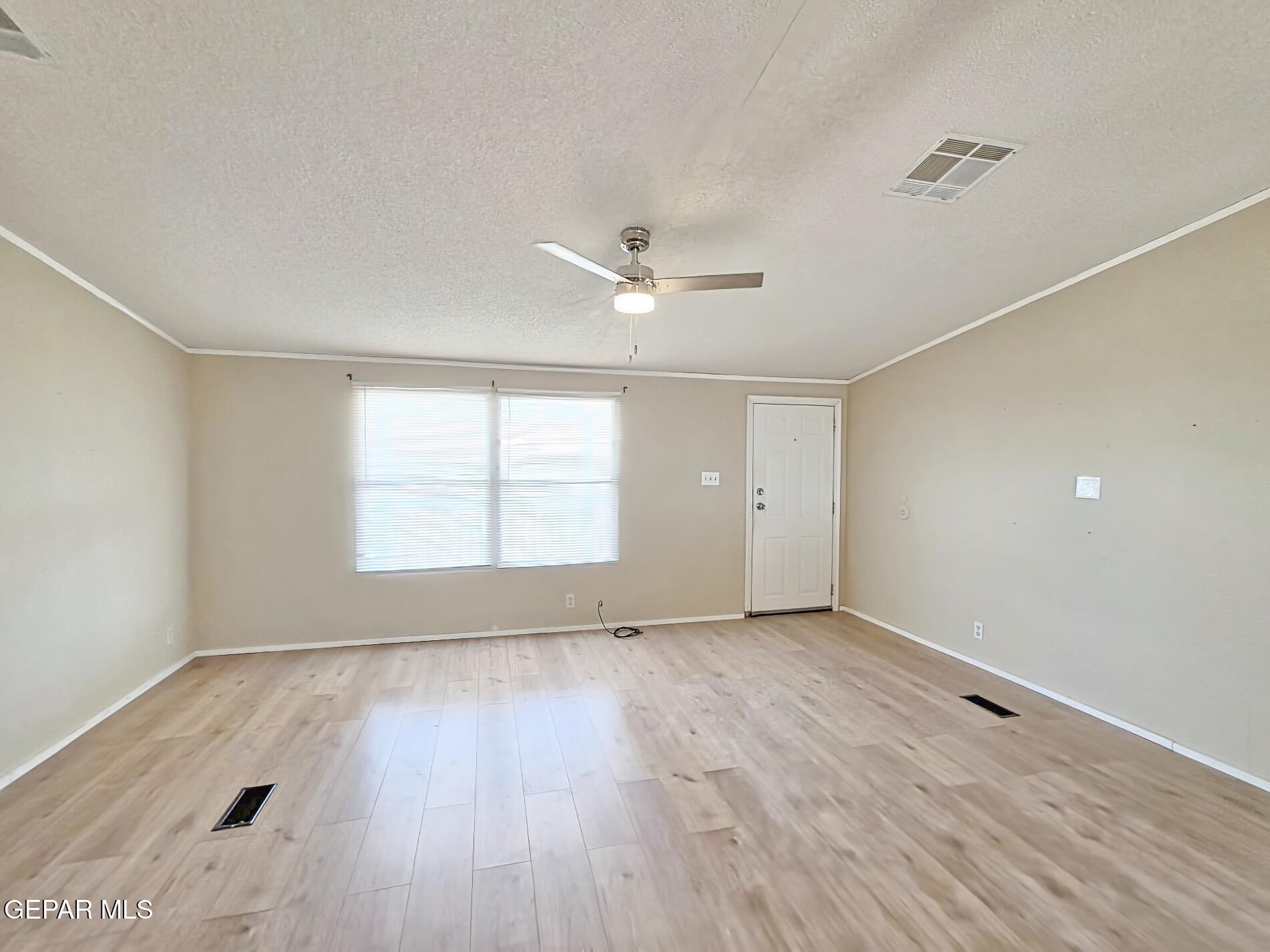 101 Clydesdale Road Dell City, TX 79847 - Photo 17 of 90 an empty room with wooden floor and windows