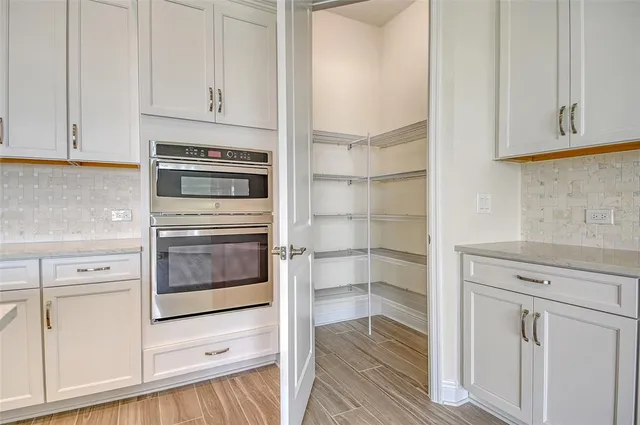 a kitchen with white cabinets and white appliances