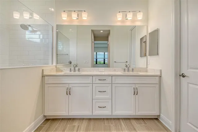 a bathroom with a sink vanity and mirror